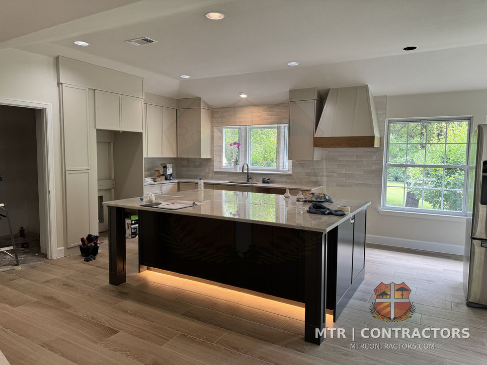 Island with under-counter LED lighting and custom range hood — whole-home remodel by MTR Contractors, Frisco TX