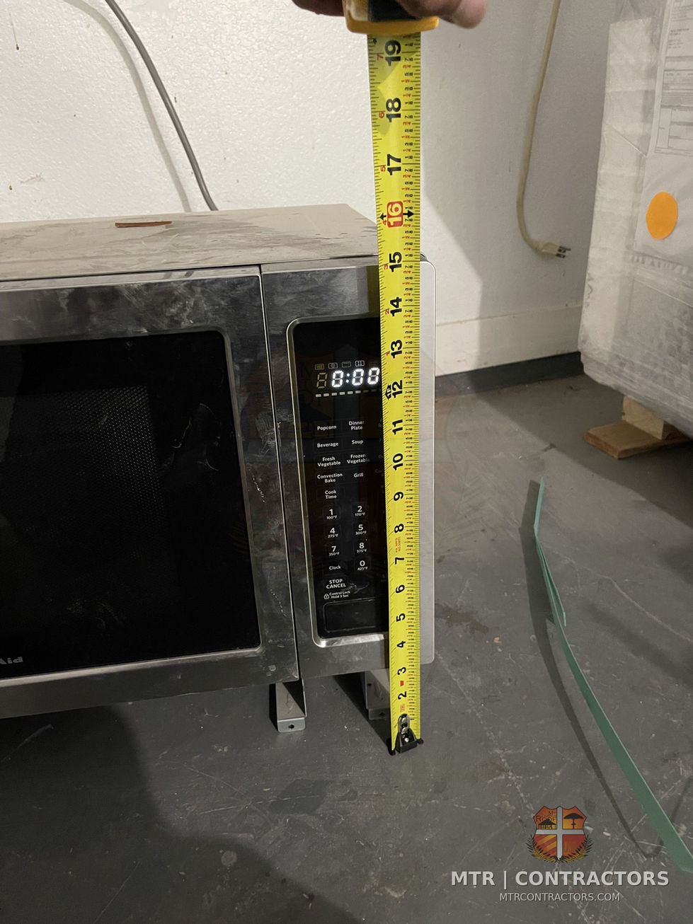 Appliance dimension check during kitchen planning — whole-home remodel by MTR Contractors, Frisco TX