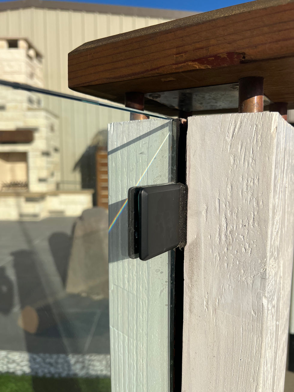 Frameless glass panel and post anchoring detail at the showroom