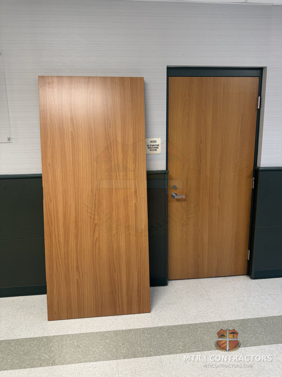 New solid-core classroom doors staged for install — Legacy Christian Academy — commercial remodeling in Frisco, TX