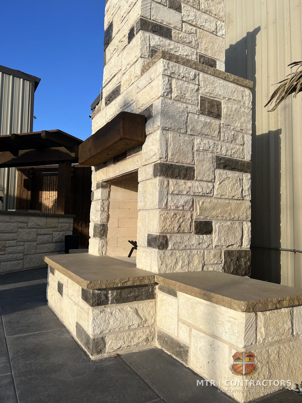 Outdoor fireplace chimney showing stone coursing and mortar joint detail — outdoor living showroom in Frisco, TX