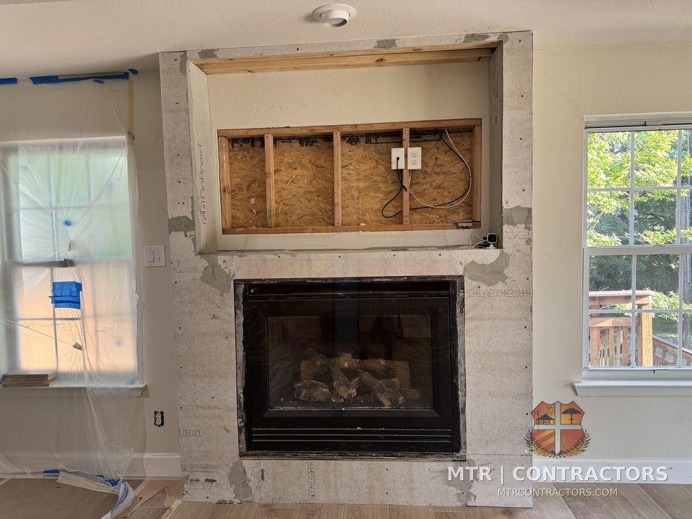 Fireplace with stone surround and framed TV niche — whole-home remodel by MTR Contractors, Frisco TX