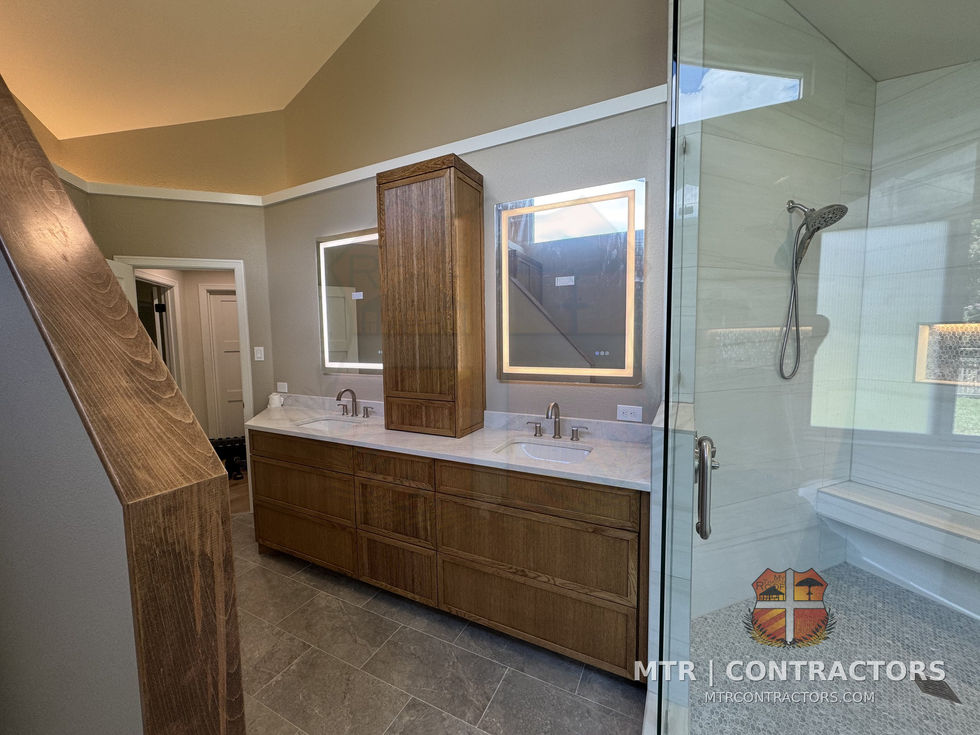 Double vanity with lighted mirrors and frameless shower — whole-home remodel by MTR Contractors, Frisco TX