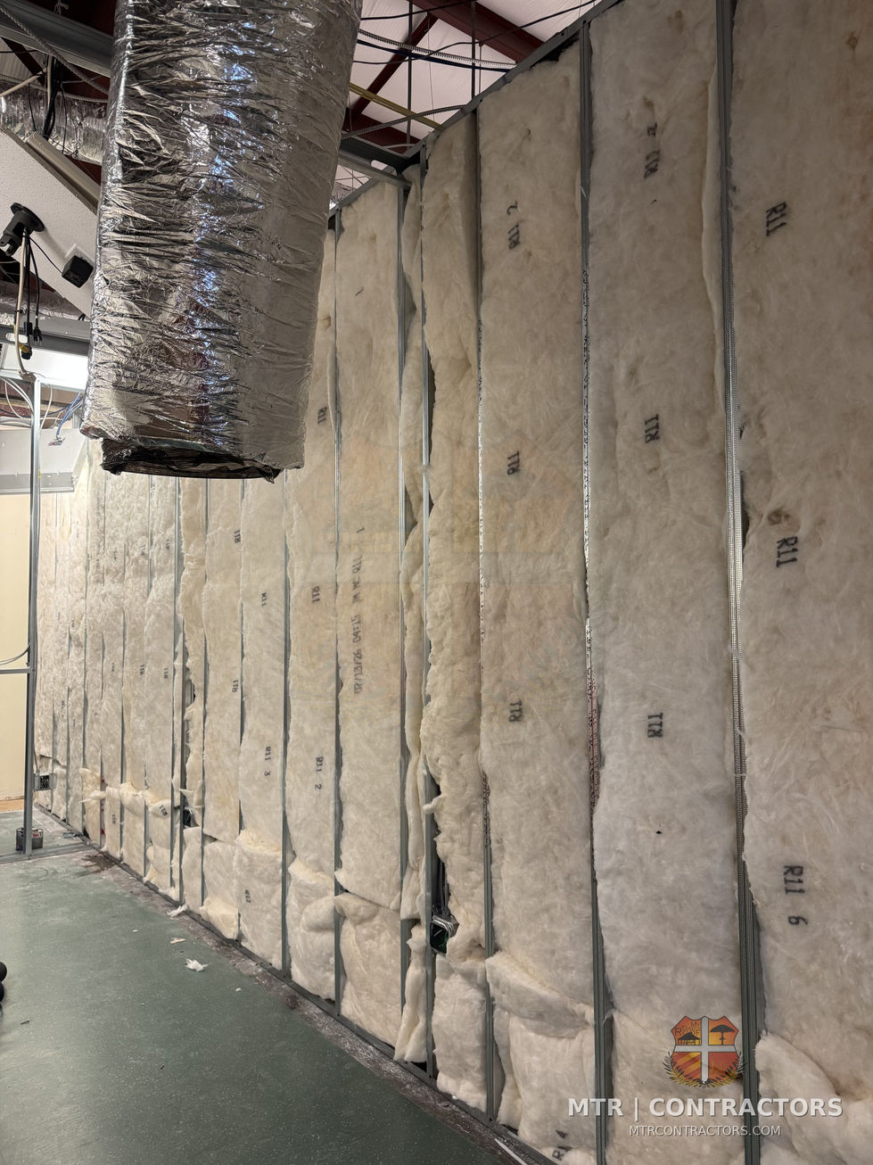 Insulated classroom partition walls before drywall — Legacy Christian Academy — commercial remodeling in Frisco, TX
