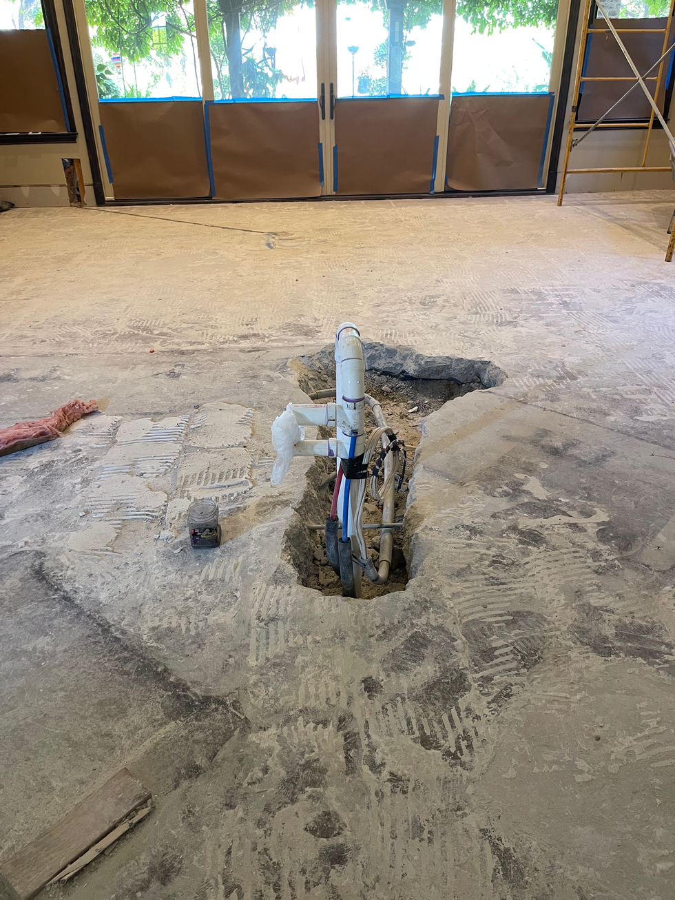 Slab cut open for new plumbing and gas lines serving the relocated island