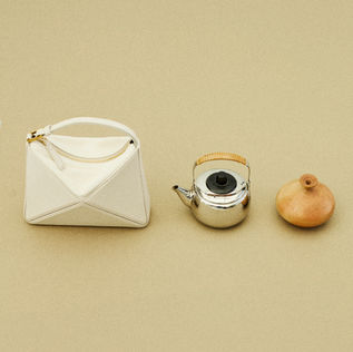 Inspired by Eastern minimalism and the beauty of imperfection, this still life editorial explores the dialogue between raw textures and refined jewellery. Through folded paper, fractured porcelain, and organic forms, we celebrate 'Wabi-Sabi' — the art of finding sublimity in the simple, the quiet, and the transient. By pairing contemporary jewellery from emerging designers with everyday objects, such as newsprint, matchboxes, mochi, and wrapped sweets, the imagery finds beauty in the mundane. It is a thoughtful exploration of form and texture, where modern design meets daily rituals in a refined, poetic balance. Photographed by Ada Diren Kurt. Fashion Editor by Büsra Kahveci. Art Direction by Eylül Günaydinlar.