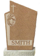 A light brown cemetery monument with a cross engraved on it