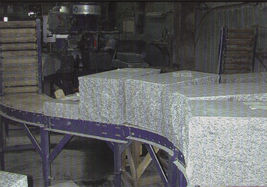 Square blocks of stone on a conveyor belt