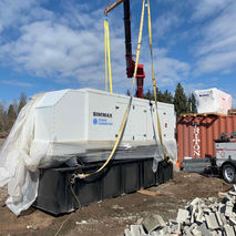 A large generator being hauled using a crane