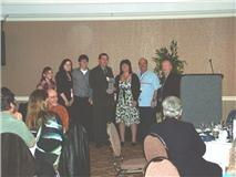 People standing and having their picture taken at a formal event