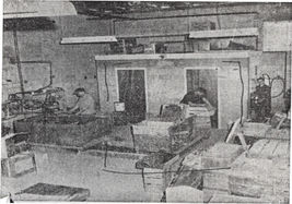 An old black and white picture of workers in a workshop