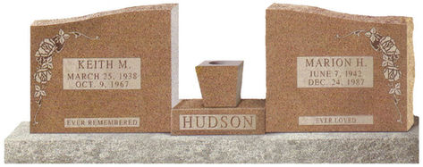 A brown cemetery monument with matching structures for two individuals
