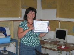 A woman holding up certificate
