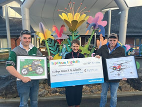 Farmers hand over cheque to charity following festive tractor run