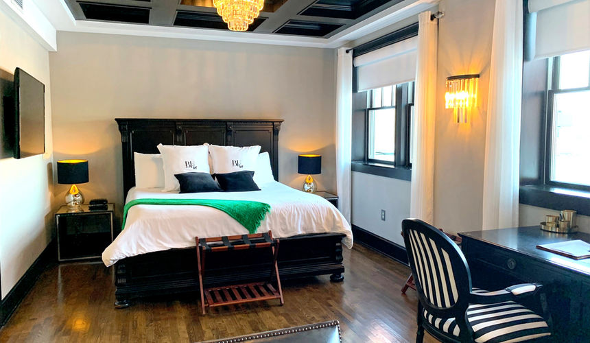 Dark wood ceiling, chandelier bedroom, Emerald Room, elegant room, Pioneer Woman Boarding House Hotel, Pawhuska, Oklahoma