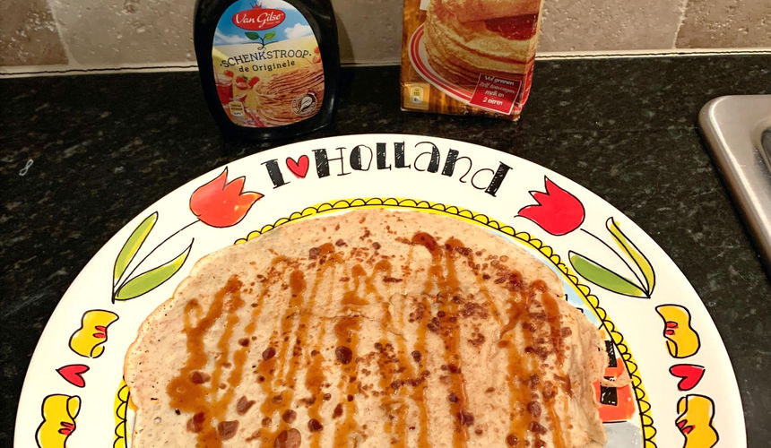 Dutch pancake pannenkoek with syrup, pannenkoek met stroop. Blond Amsterdam plate, koopmans mix.