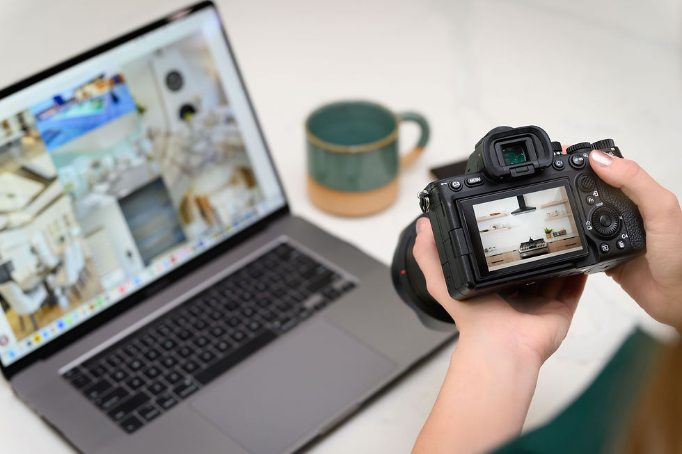 Ashley Blackmer Real estate photographer reviewing interior kitchen shot on camera with listing photos open on laptop in Sacr