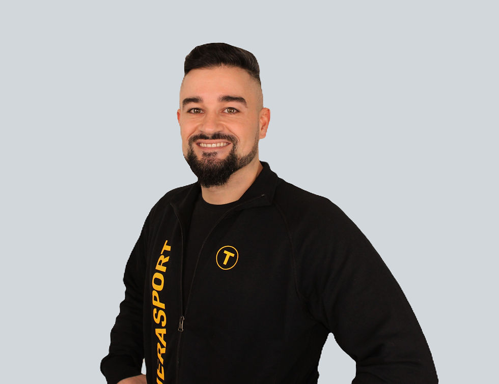 Smiling man wearing a black Therasport branded jacket.