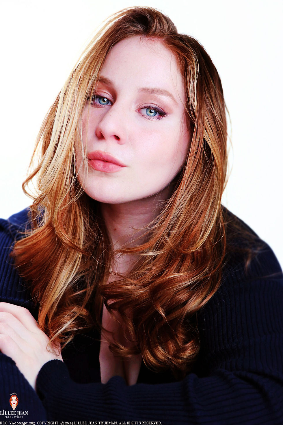 Woman with wavy red hair and blue eyes in a black sweater against a white background. Calm expression. "Lillee Jean Productions" text below. Official Editorial Series: Lillee Jean Editorials of Twenty-Four. Directed by Lillee Jean. This image is part of a 560-photo group registration (VA0002501283). Subject is Actor/Director Lillee Jean Trueman. All rights reserved. JUNE 2024.