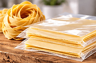 Fresh pasta: Fresh pasta sheets separated and protected by clear packaging film.