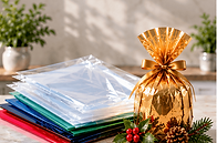 Christmas puddings: Wrapped Christmas pudding beside a stack of coloured packaging sheets.