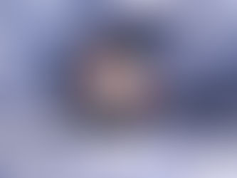 Artistic rendition of a sugar skull surrounded by red flowers and green leaves on black background applied to mug.