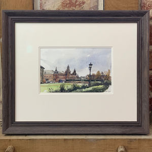 A watercolour painting of Kelvin Hall in Glasgow framed in a wooden frame.