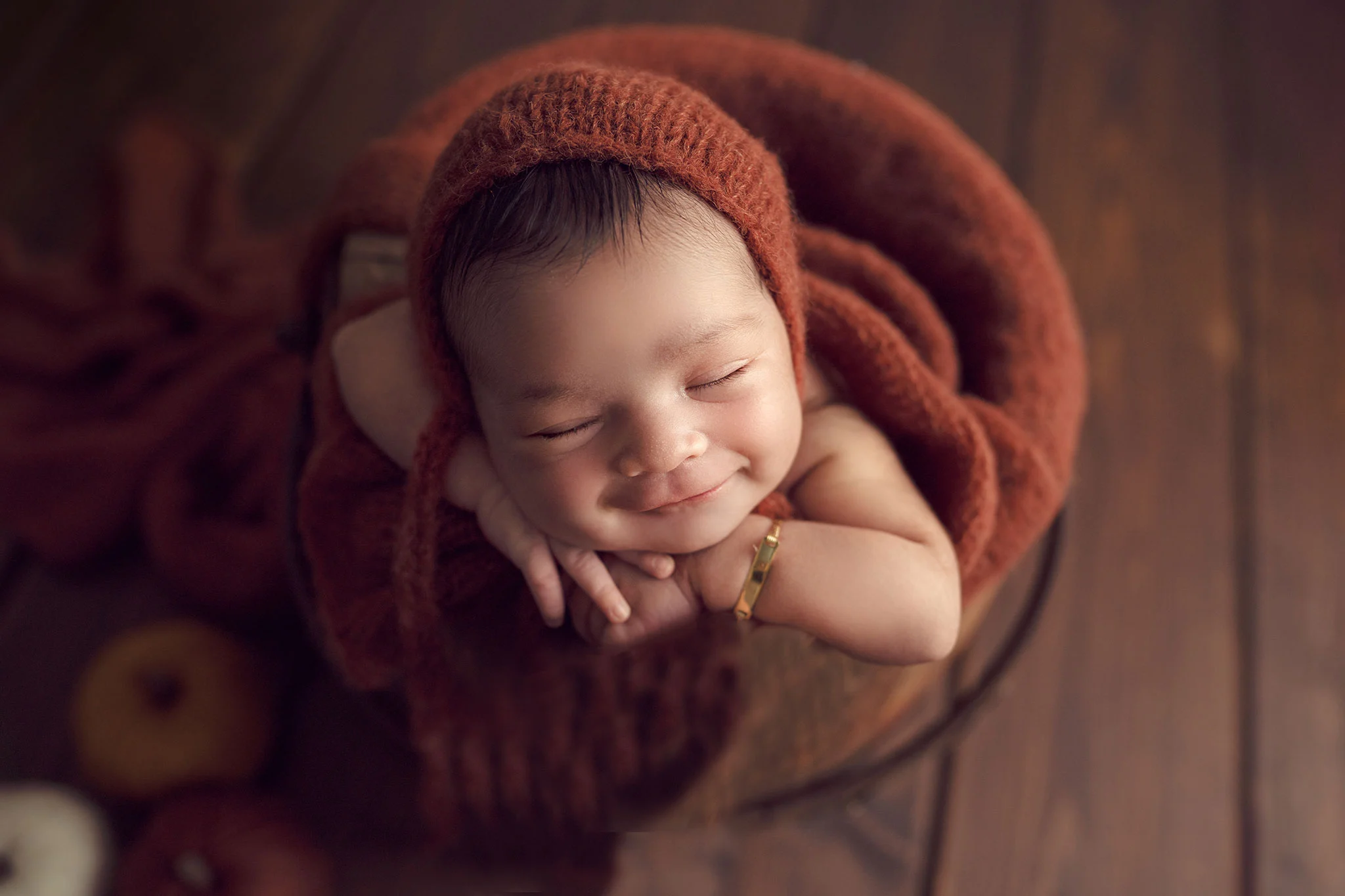 fall themed newborn photo in rust color with honey bucket taken by NH newborn photographer Vanessa Keo