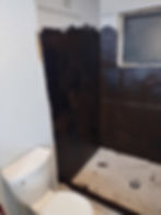 Bathroom shower area during professional renovation services.