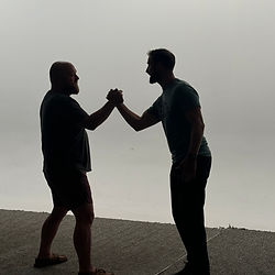 Two men shaking hands in an improv scene