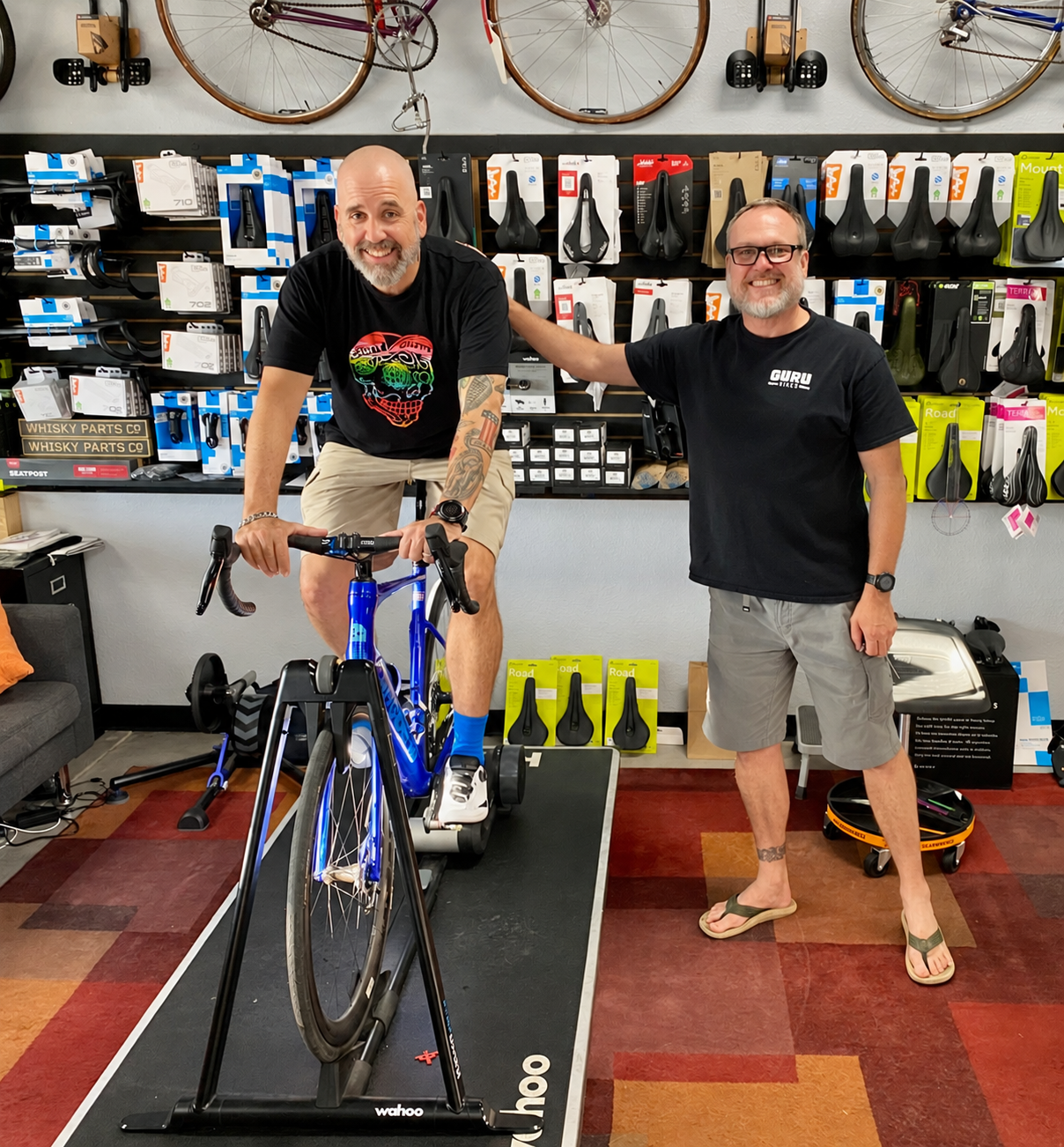 Tyler with a smiling rider on a road bike at Guru Bikes