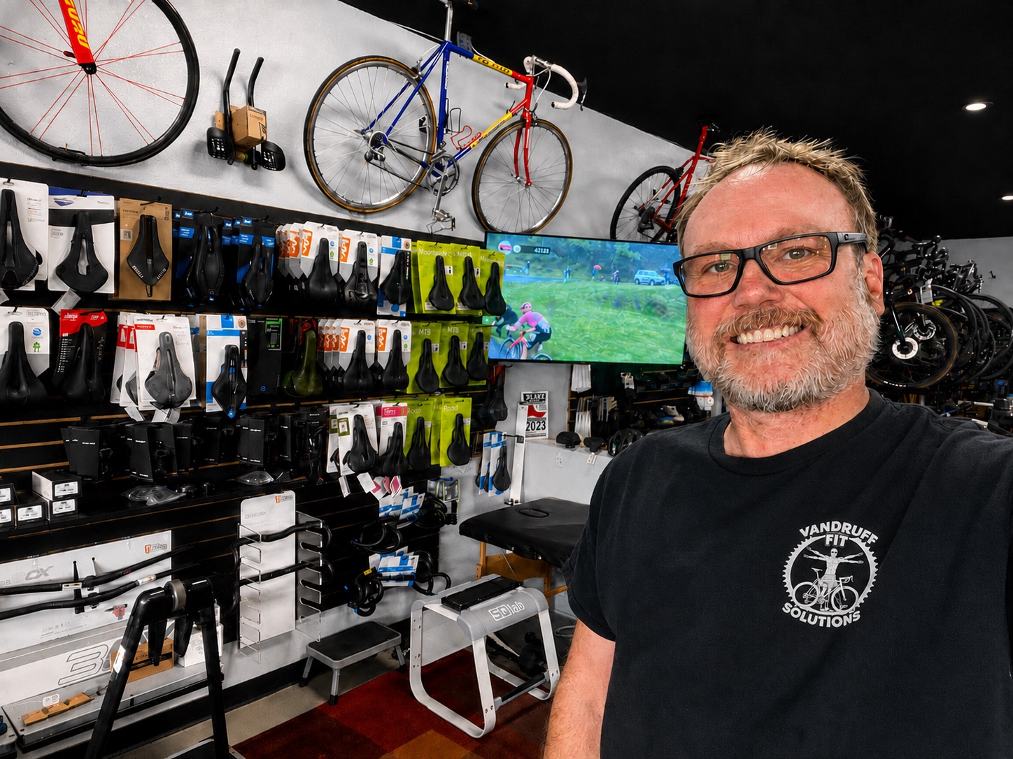 Tyler Vandruff wearing a Vandruff Fit Solutions shirt inside Guru Bikes