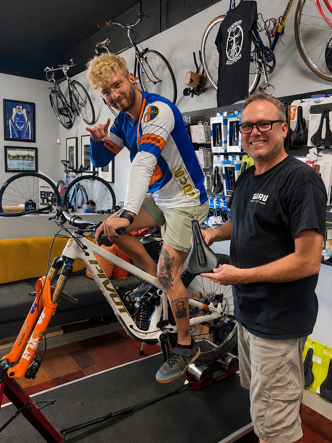 Tyler with a mountain bike rider in the fitting studio