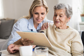 An aged care worker assisting an older person