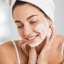 A woman exfoliating her skin