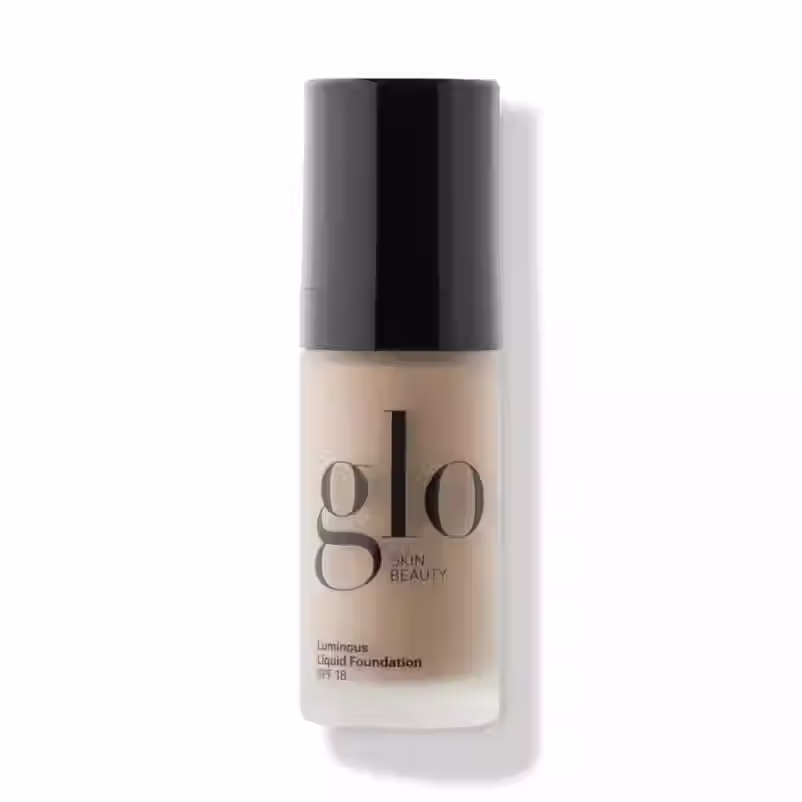 GLO SKIN BEAUTY ŠVYTĖJIMO SUTEIKIANTIS SKYSTAS MAKIAŽO PAGRINDAS  TAHINI ATSPALVIS
