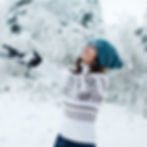 Woman playful and happy in the snowfall