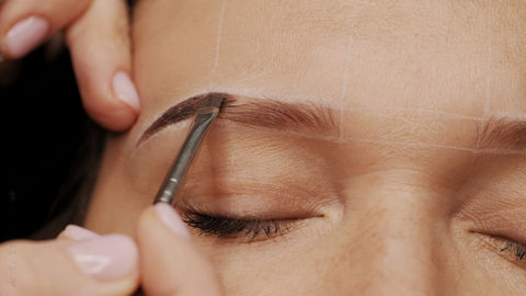 A semi-permanent cosmetic tattooing procedure that uses a manual hand tool to deposit pigment into the skin to create the appearance of fuller, more defined eyebrows.