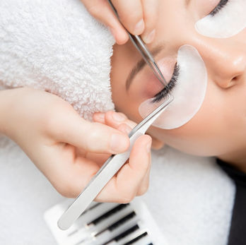 A cosmetic procedure that involves applying individual or cluster of artificial lashes to natural lashes to create a fuller, longer appearance.