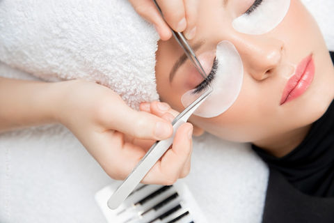 A cosmetic procedure that involves applying individual or cluster of artificial lashes to natural lashes to create a fuller, longer appearance.