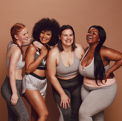 Mix race women in athletic wear posing against a solid brown background