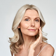 Middle age woman posing against a solid background close up of her face