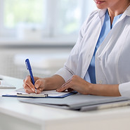 doctor taking notes on note pad