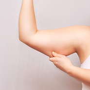 Hand pinching other arm's tricep