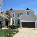 exterior house in an off white with a brighter white trim and black doors