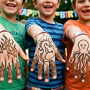 3 young boys at a birthday party showing henna tattoos with fun kids patterns like, dragon