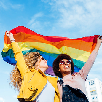 two-women-hanging-out-in_the-city-waving-LGBT-with-pride-flag.png