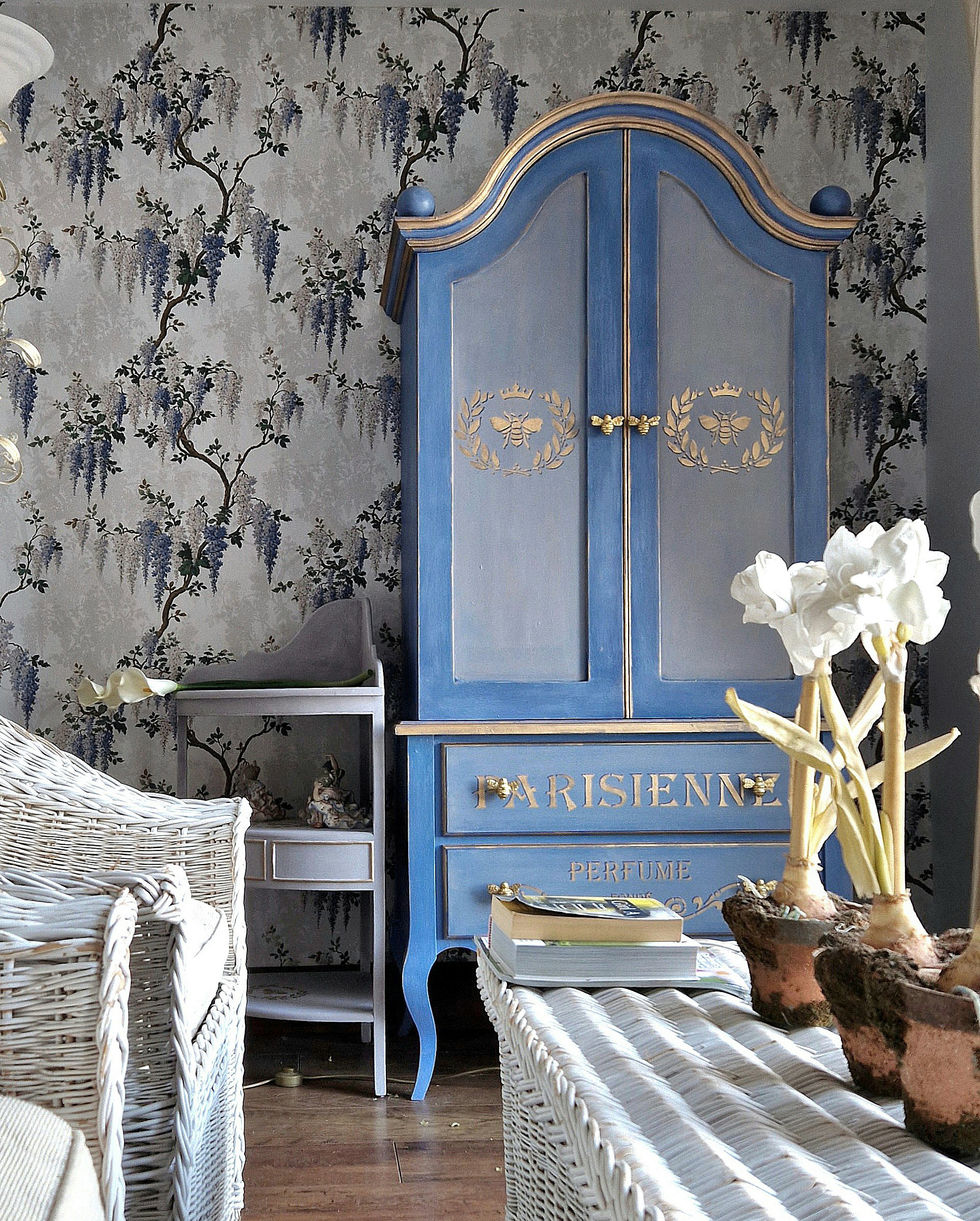 hand painted blue cupboard against Woodchip and Magnolia wisteria wallpaper