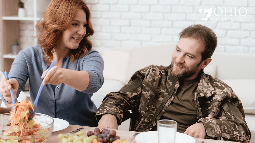 Woman is serving veteran food at dinner table