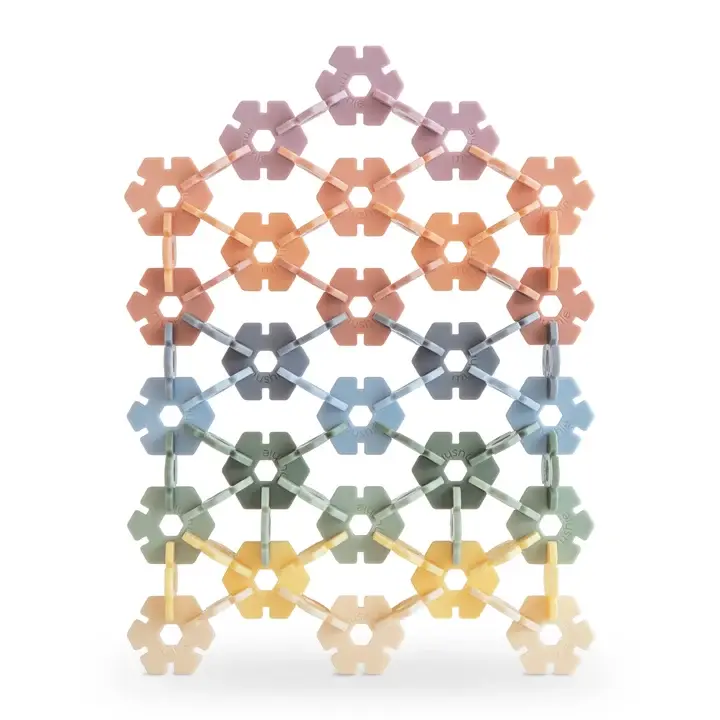 Mushie Hex Connect building toy set connected into a tall lattice grid showing dusty pastel hex tiles connected together.
